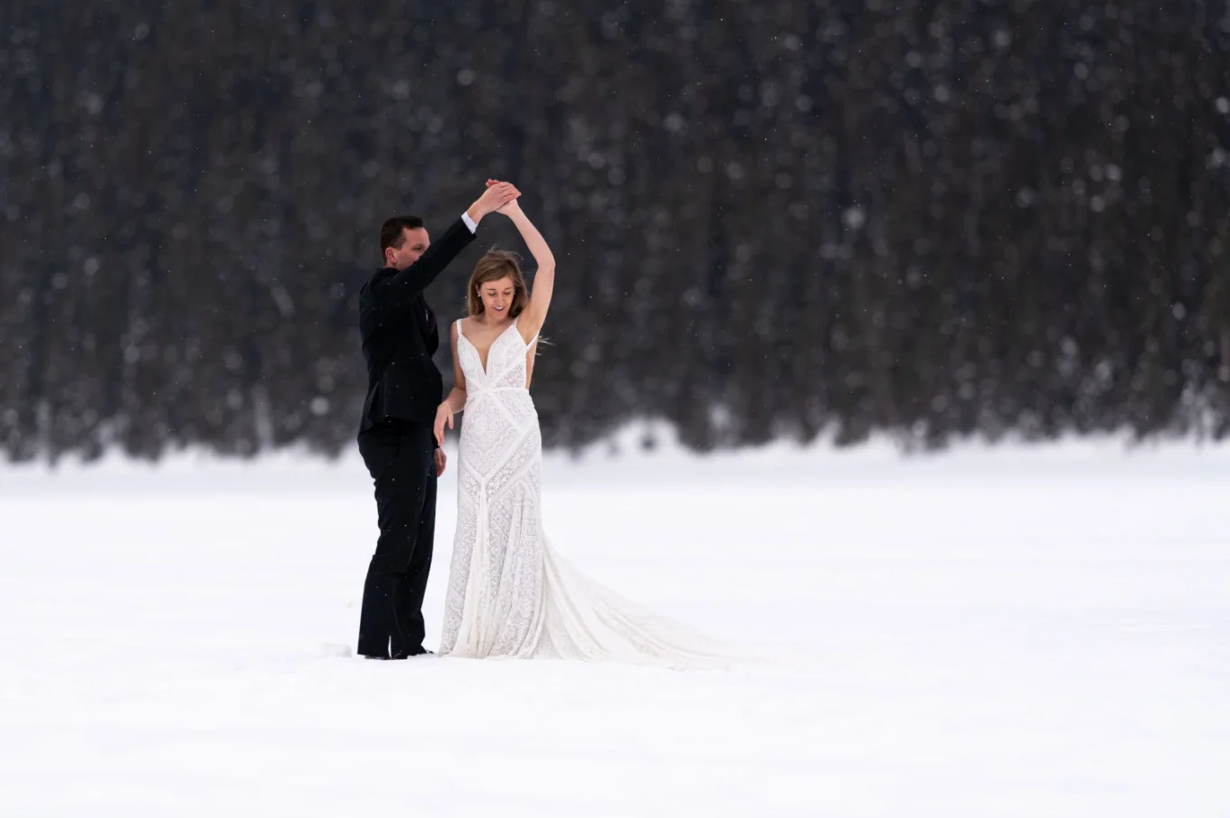 newlyweds are dancing during Banff Winter Photo Session