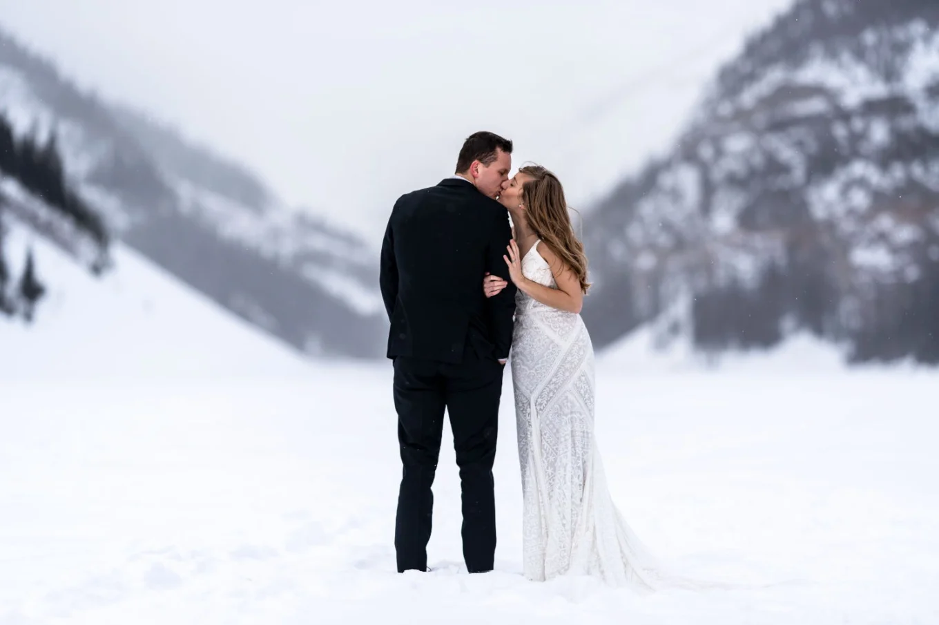 Bride kissing the groom at Lake Louise
