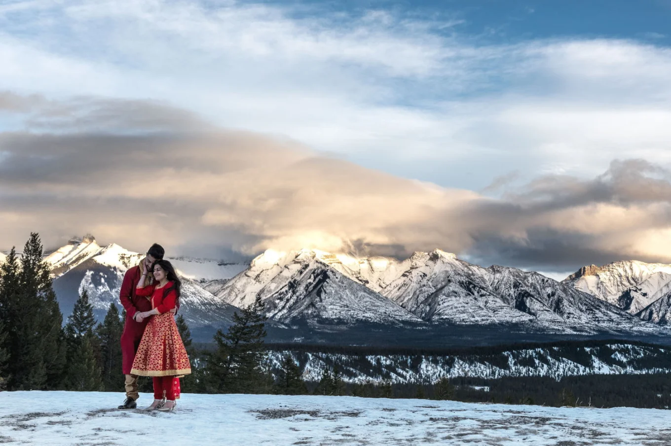 Indian couple looking at the mointains during their photo session in Banff National Park.