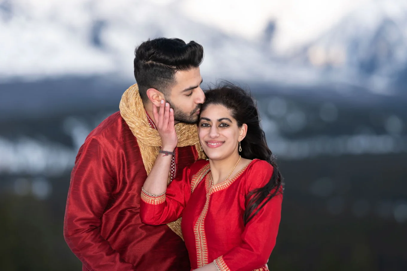 Indian husbang kissing his new wife's head during wedding ceremony in Banff.