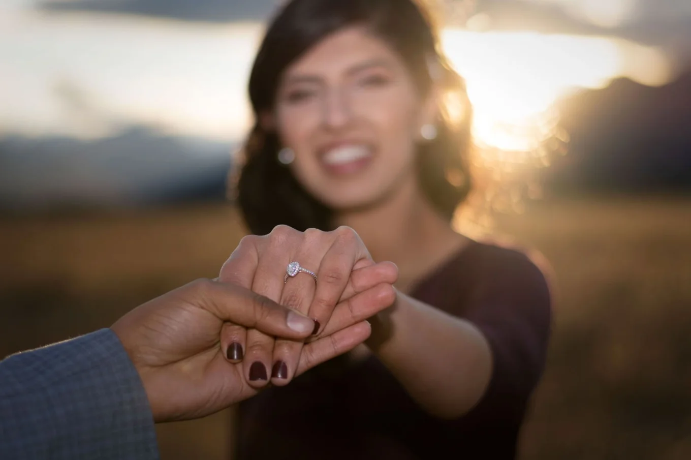 Suprised woman shows her beautiful engagement ring.