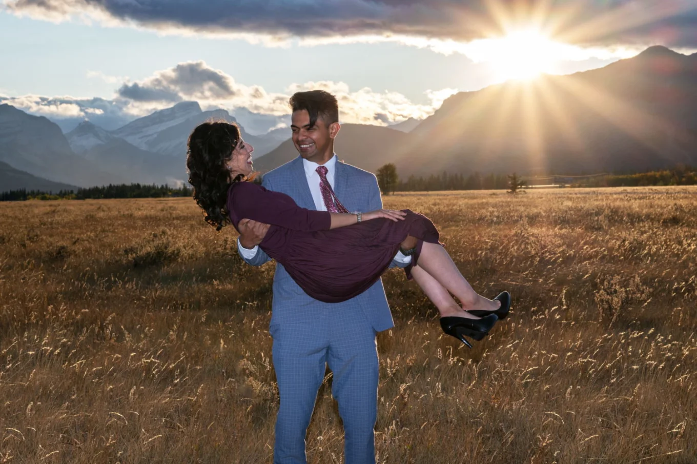 Fall engagement in Banff. A man carry his future wife on hands