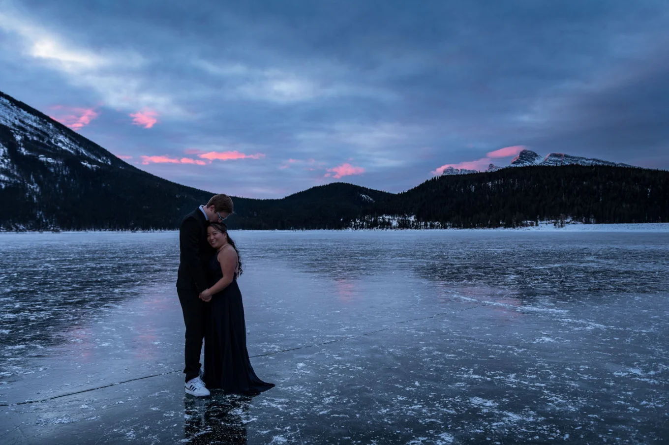 Romantic moment before the proposal. Couple hug each other during winter morning in Banff.