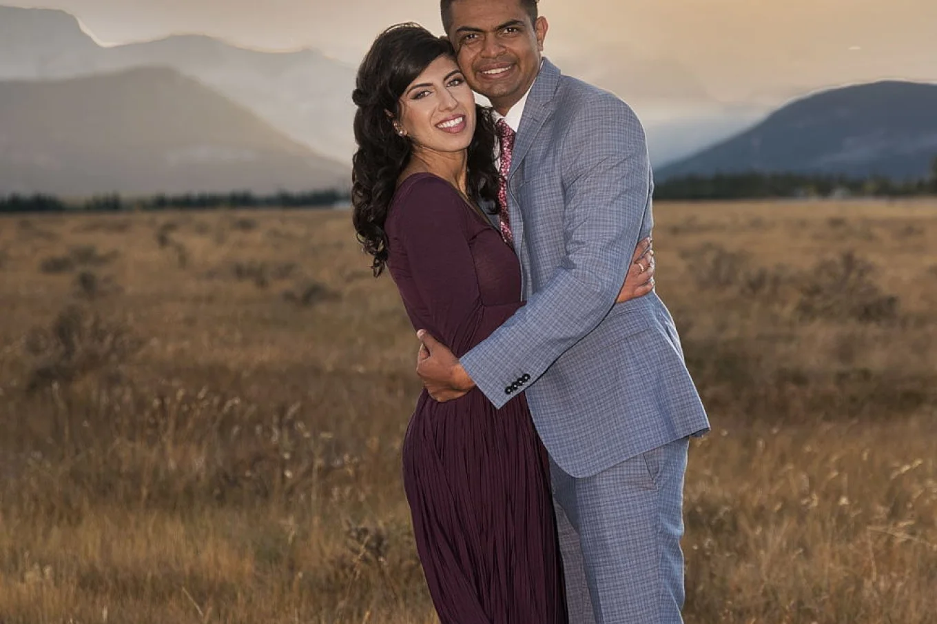 Smiling newly engaged couple posing to 4Eyes Photographer in Banff.