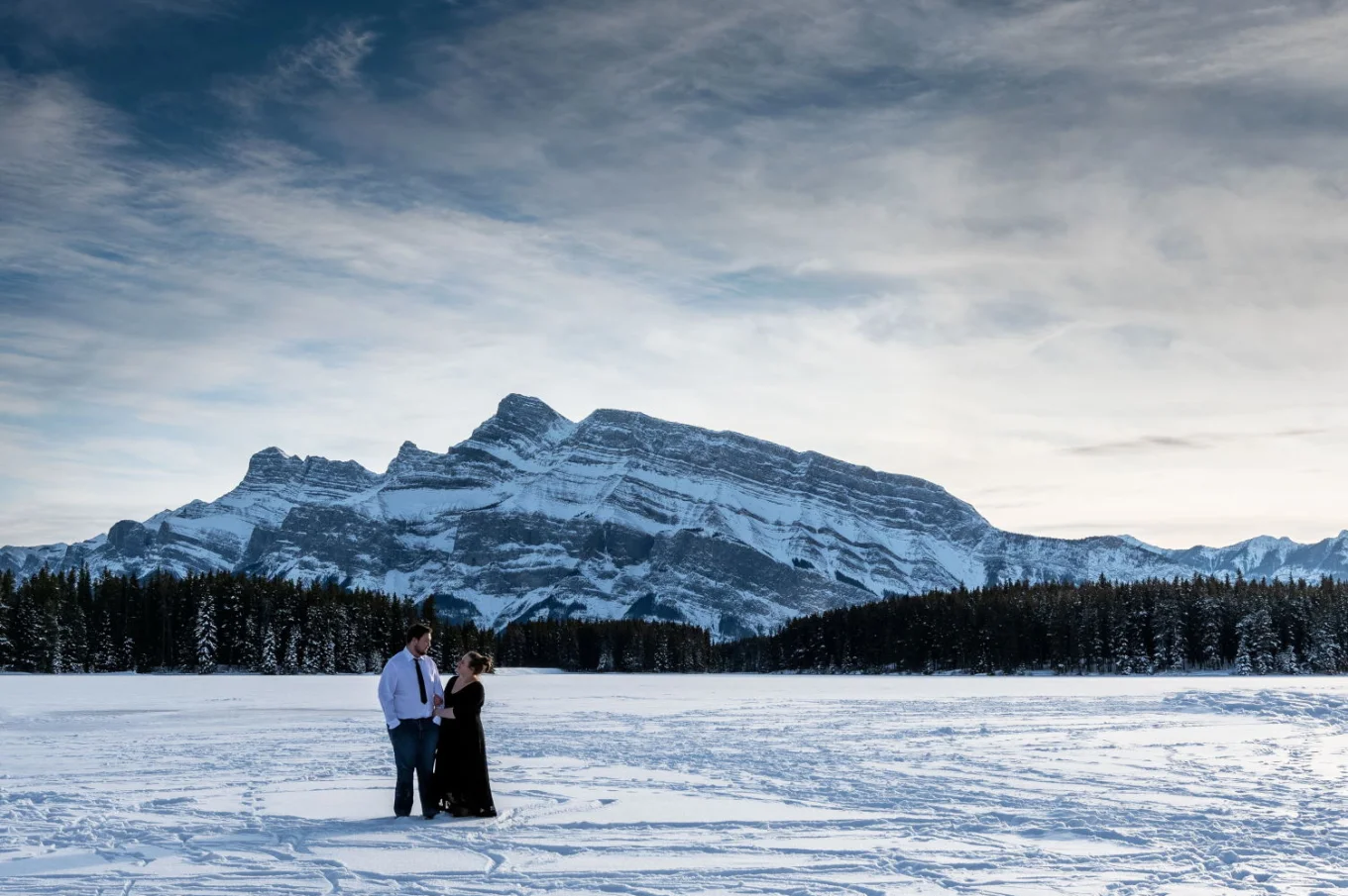 Engaged couple is posing for 4Eyes Photography during engagement photo session.