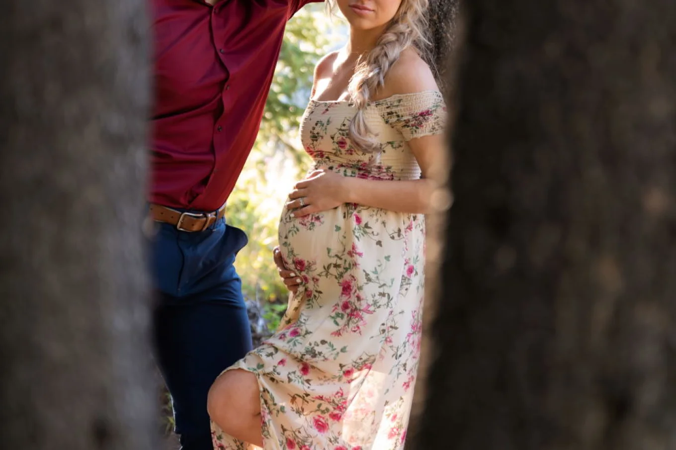 Future father looks with love on his pregnant wife. Pregnancy shoot in Banff.