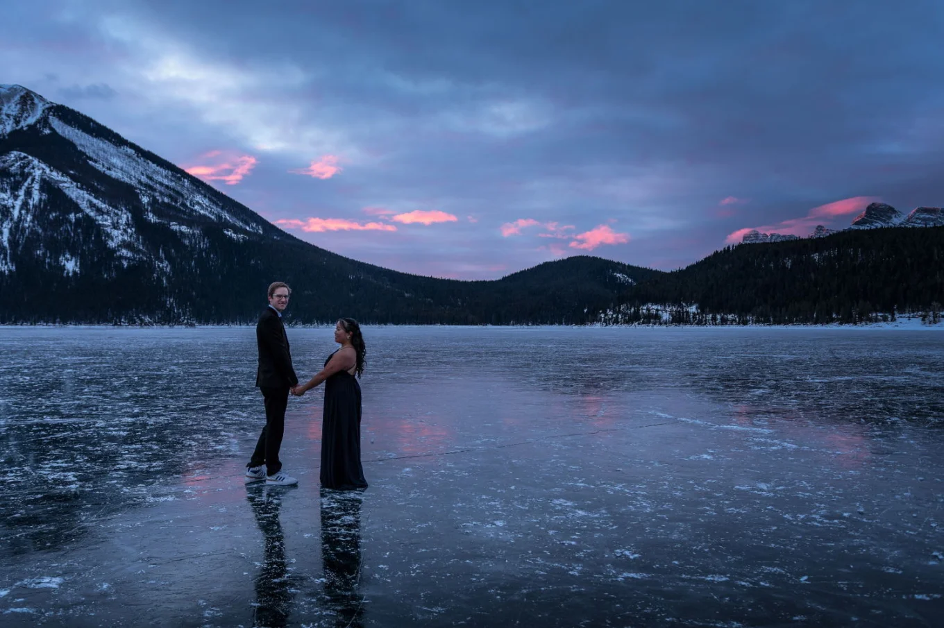 Romantic walk at Minnewanka Lake during winter sunrise