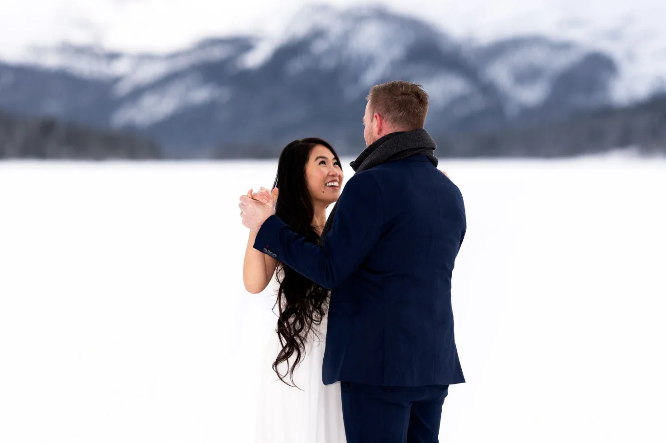 Bride and groom are dancing during their winter wedding in Banff