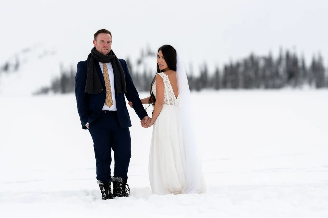 Married couple simile at the camera during after wedding session in Rocky Mountains