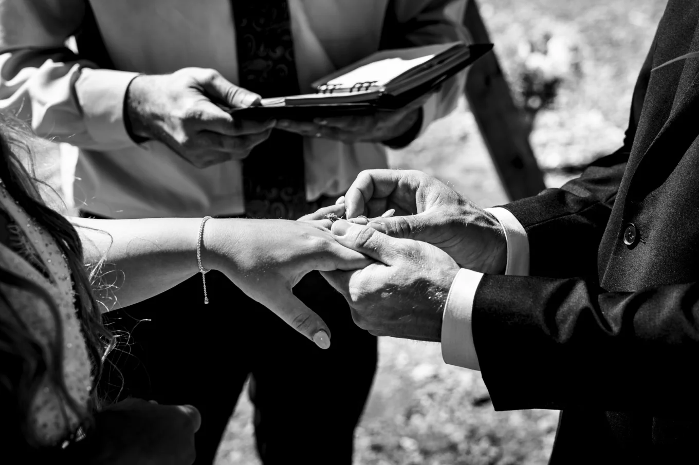 Groom puts a wedding ring on the bride's finger