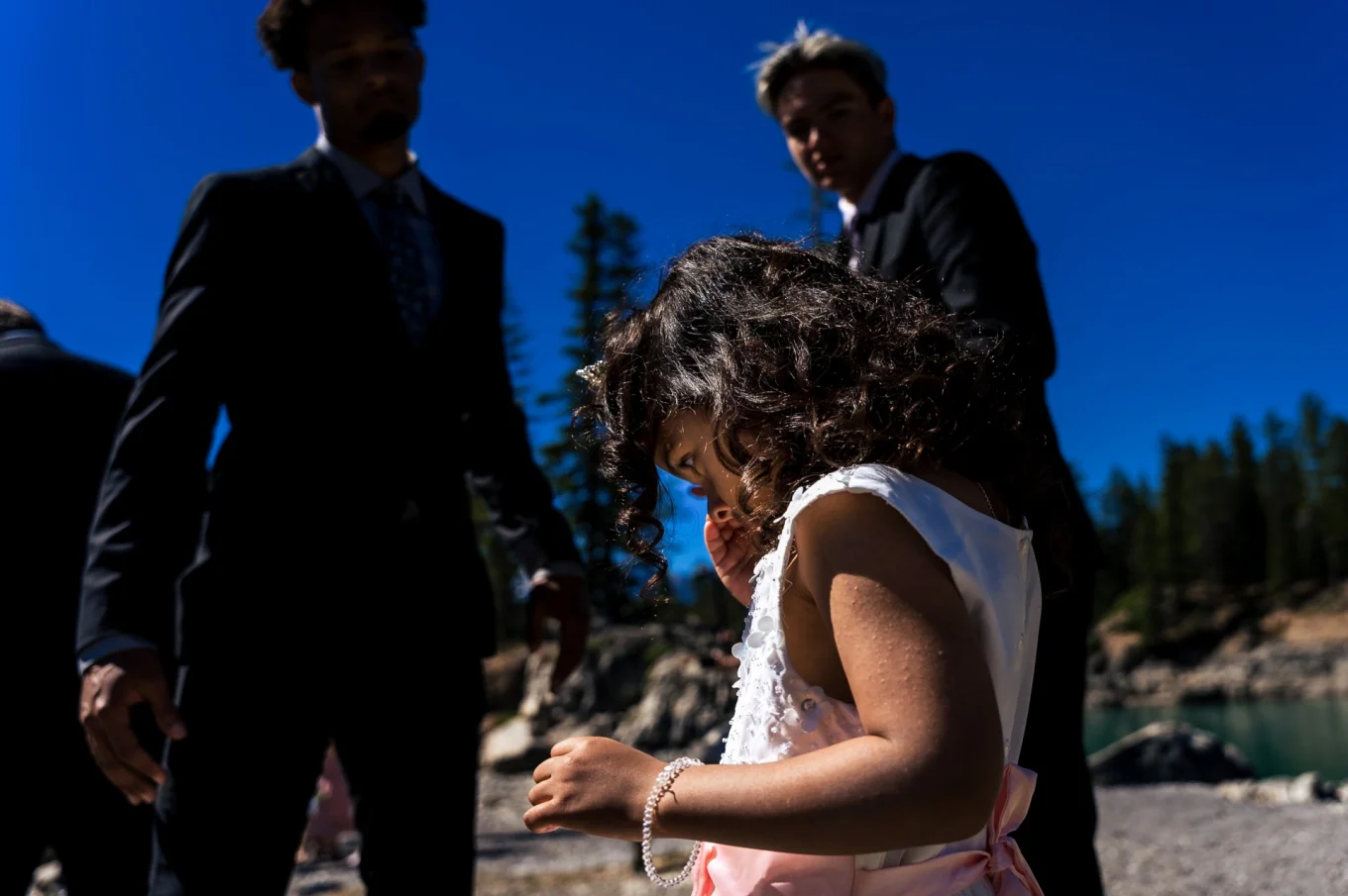 # year old daughter of the Bride cries during the ceremony at Minnewanka Lake. Banff