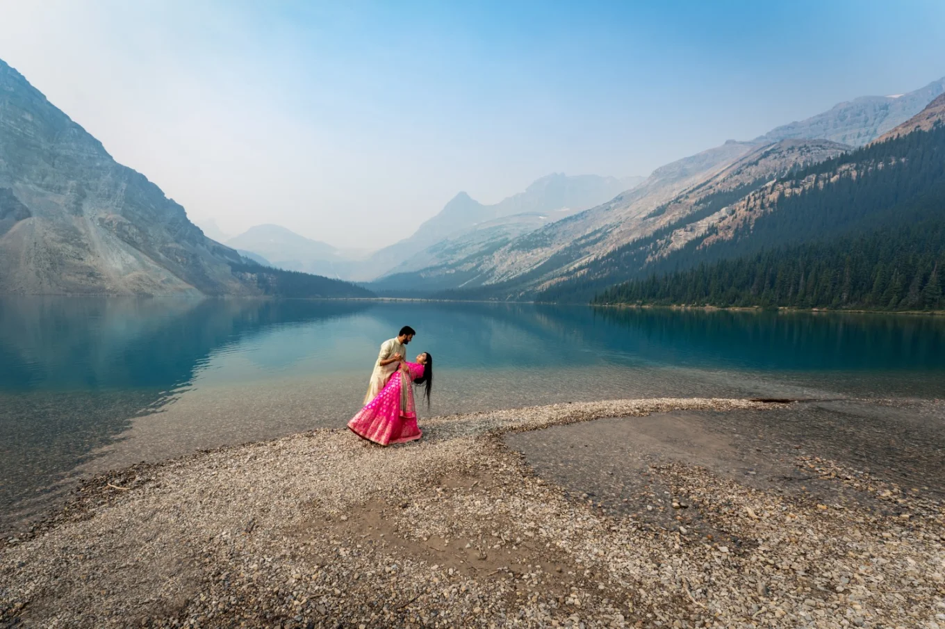 Indian lovers dancing at Bow Lake surrounded by gorgeous Canadian Rockies.