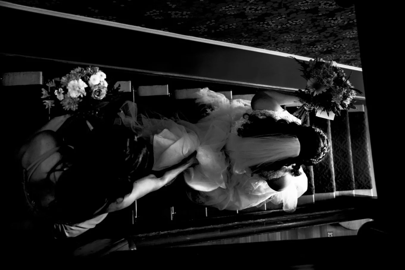 The bride is rushing to be on time for Calgary Wedding. She is running down the stairs.