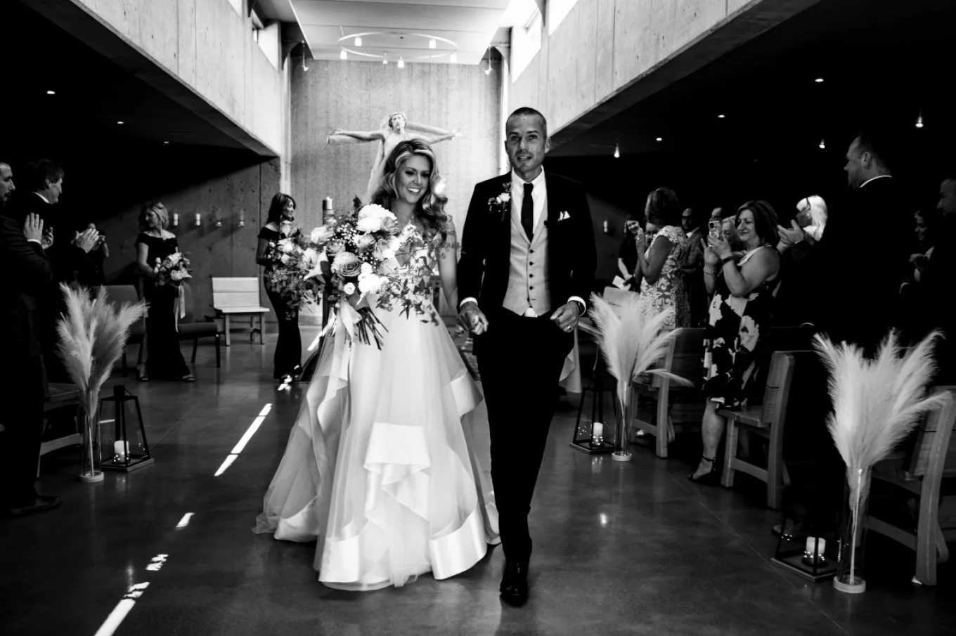 Happy Newlyweds living the church after their wedding ceremony.