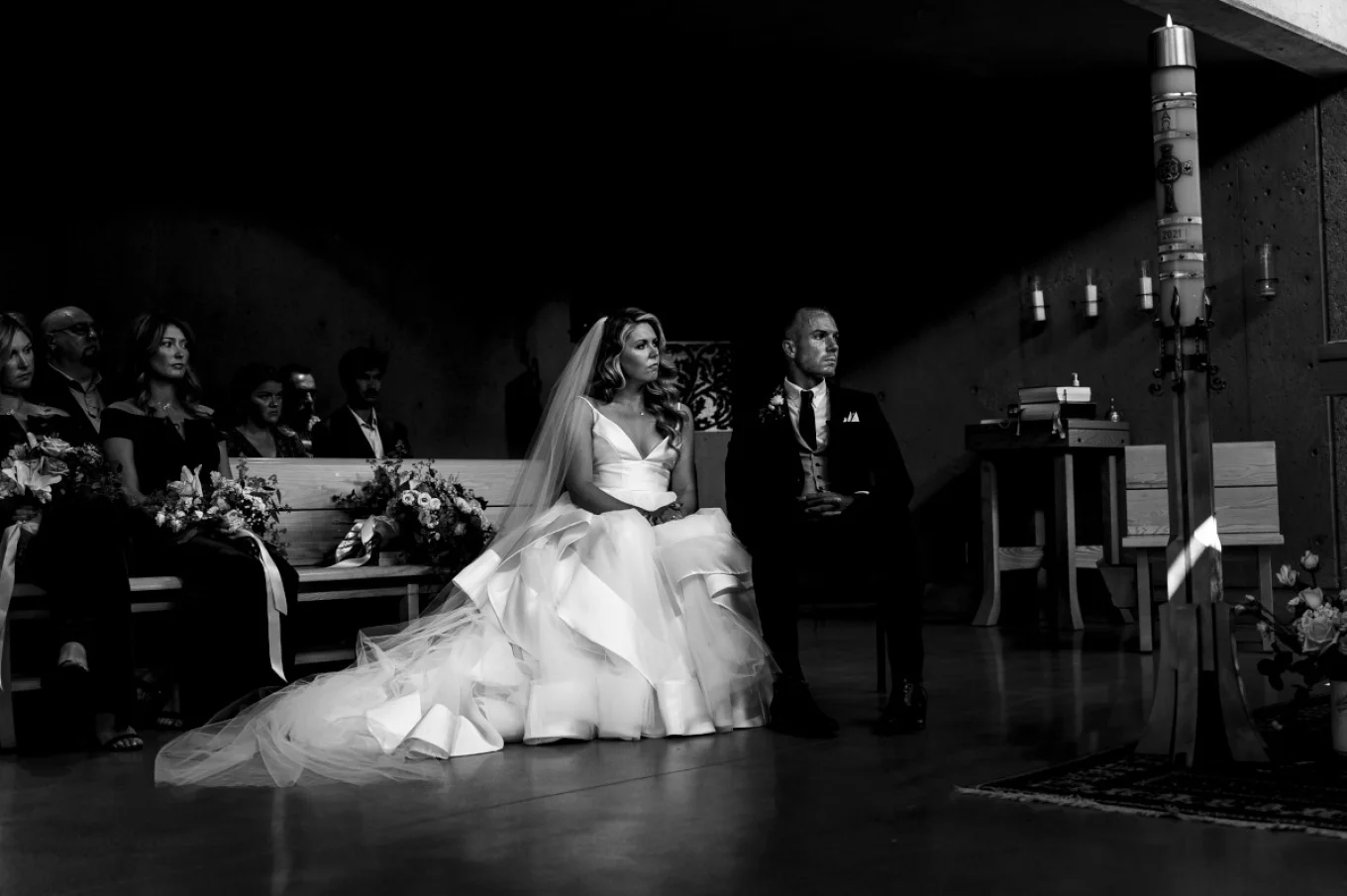 Bride and Groom are listing a reading durng Calgary Wedding Ceremony.