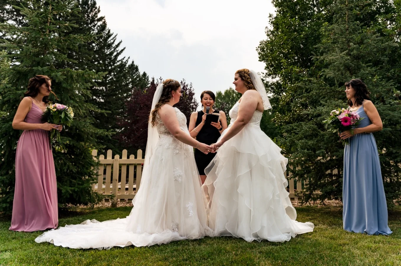 Same sex couple Calgary Wedding Photography. The brides are holding their hands and look deep at each others eyes.