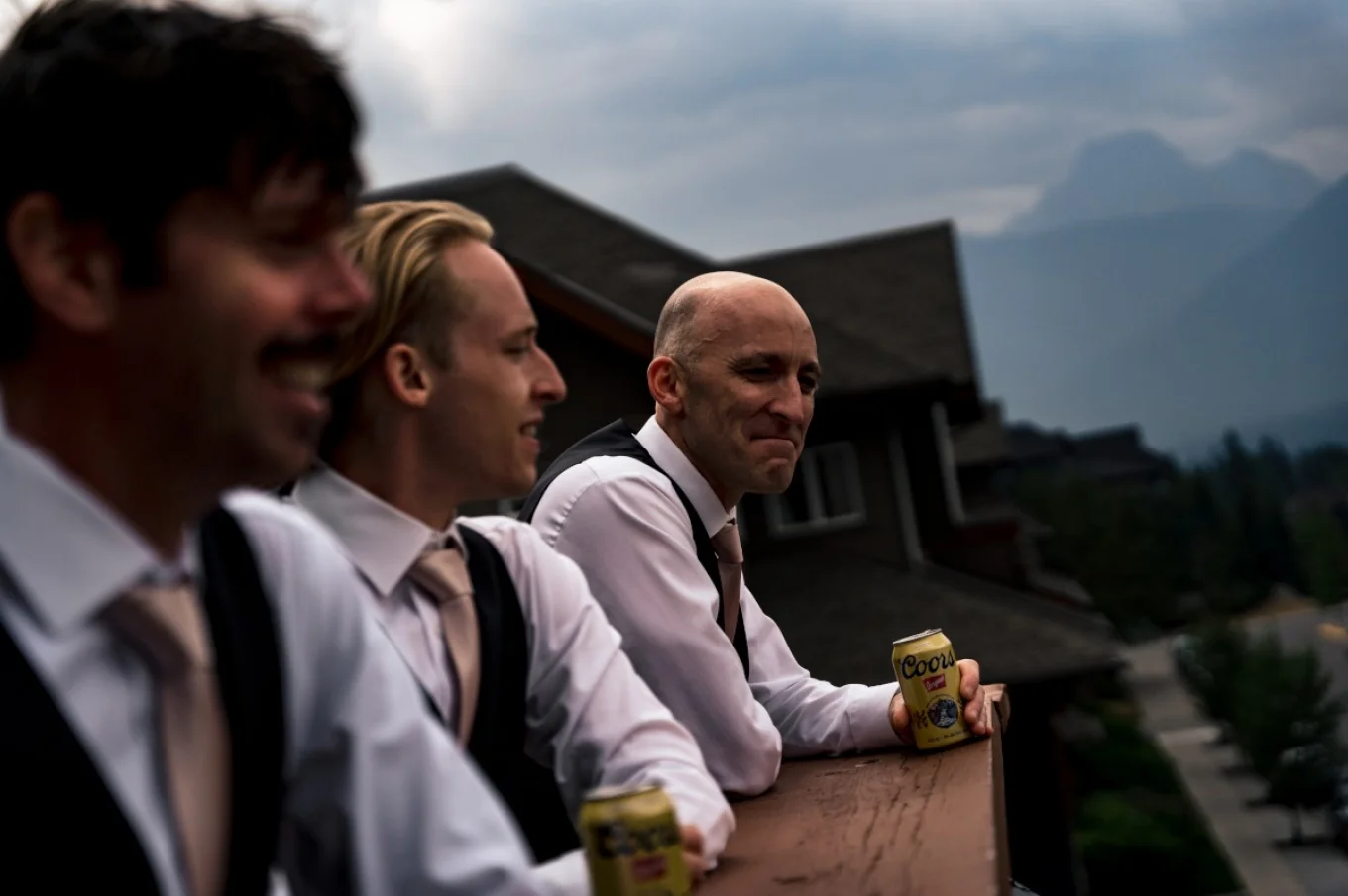 Calgary Wedding Photographer is capturing groom's and best man's good time. They are drinking a beers