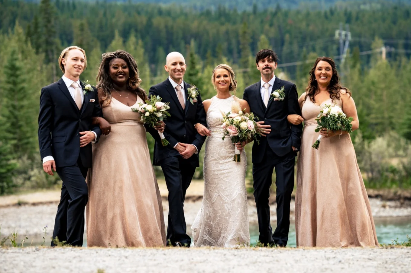 Bridal Party captured by the best Calgary Wedding Photographer. All quests are looking at the camera.