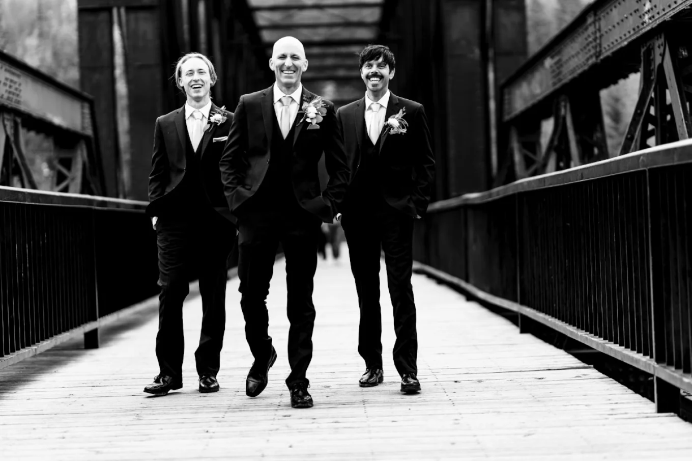 Groom and best man posing at the bride to the best Calgary Wedding Photographer