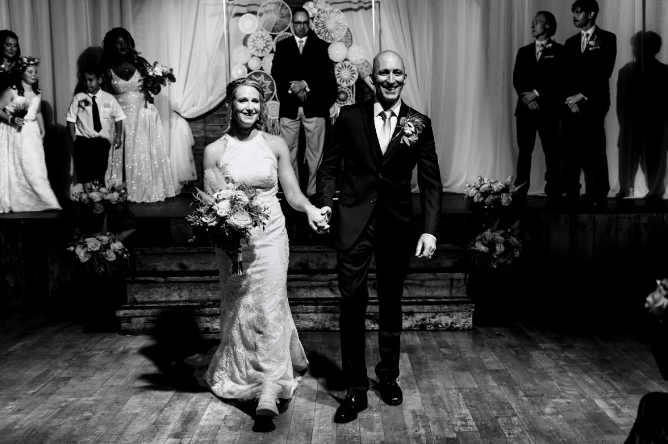Happy newlyweds walking down the alley