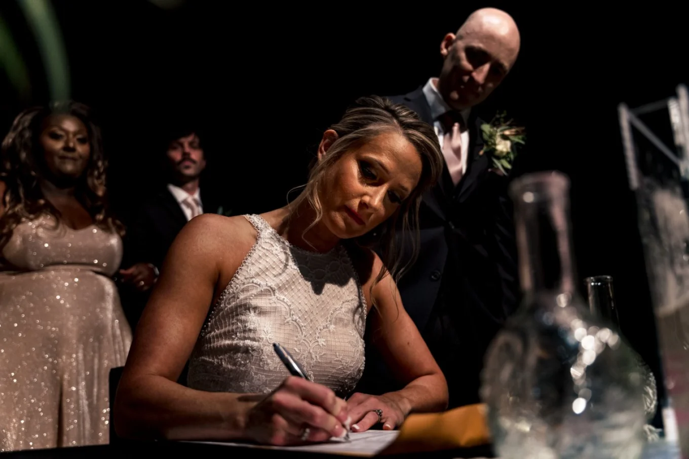 Calgary wedding photographer capturing signing the wedding papers by bride