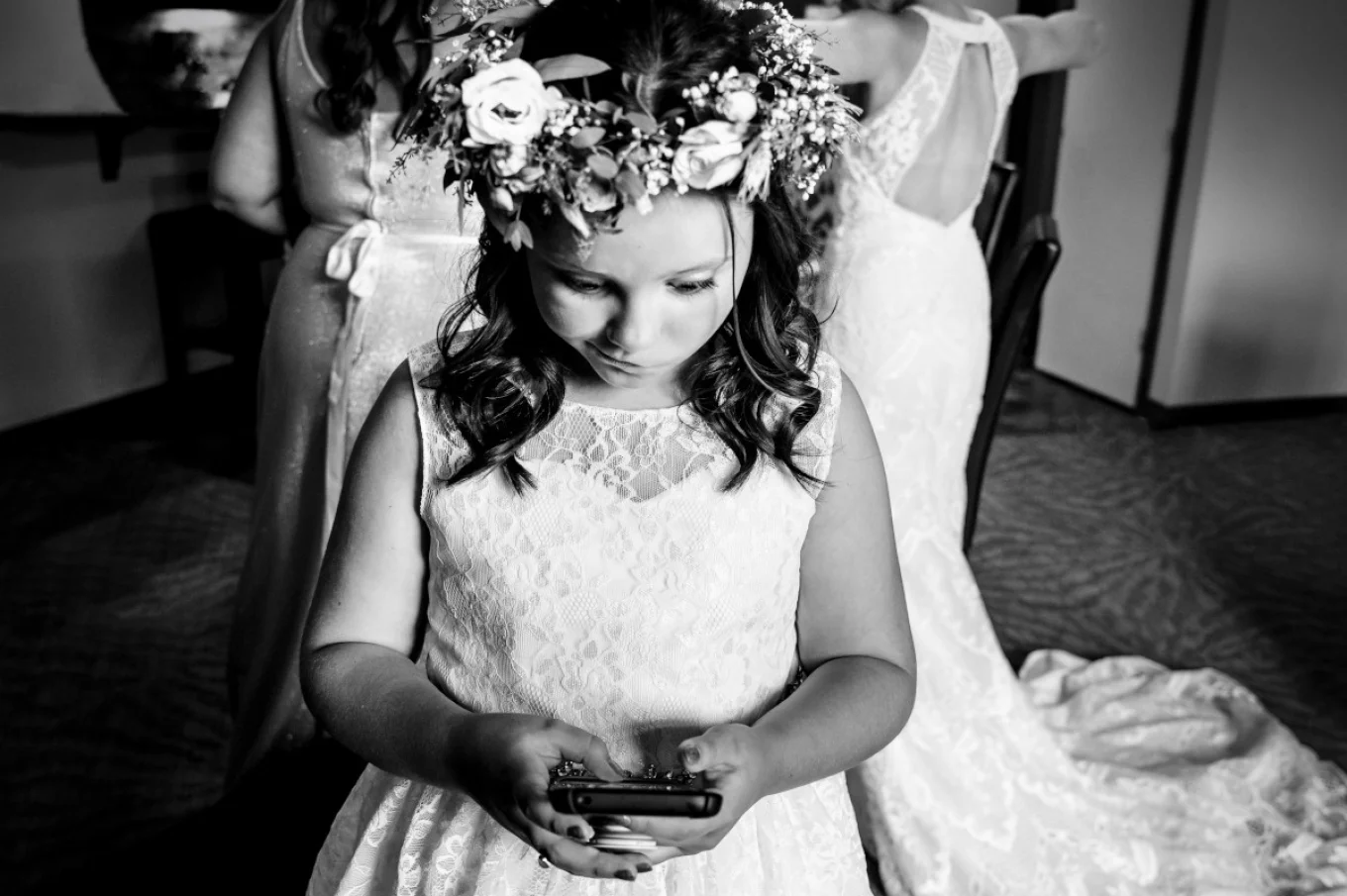 Flower girl is playing with her cellphone during Calgary Getting Ready Time