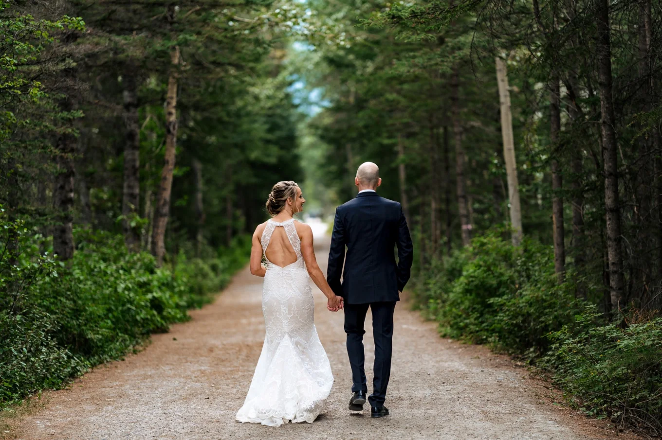 Newlyweds walking in the forest in Calgary