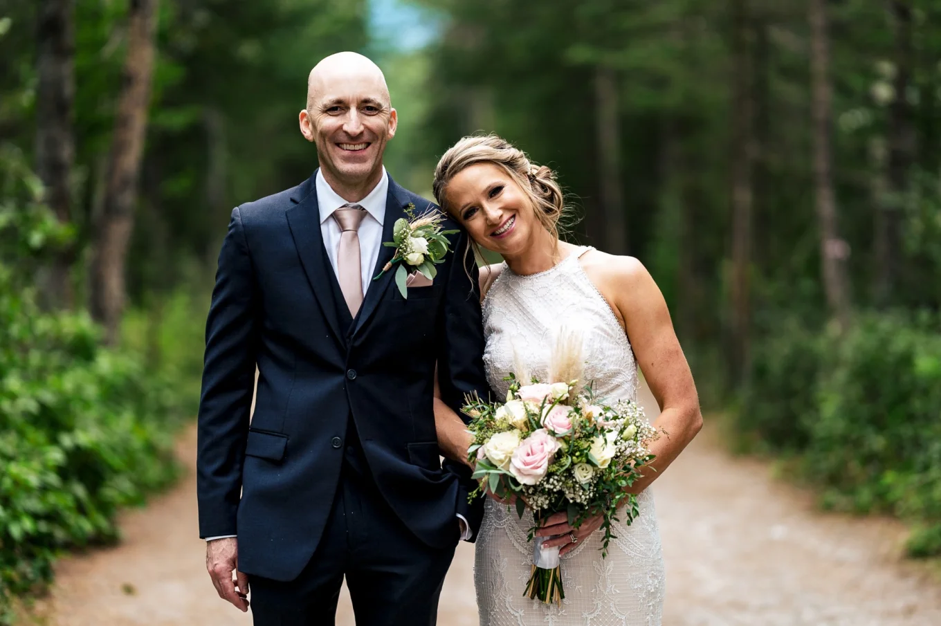 Bride's and Groom's Portrait. They are looking at the camera's of Calgary Wedding Photographer