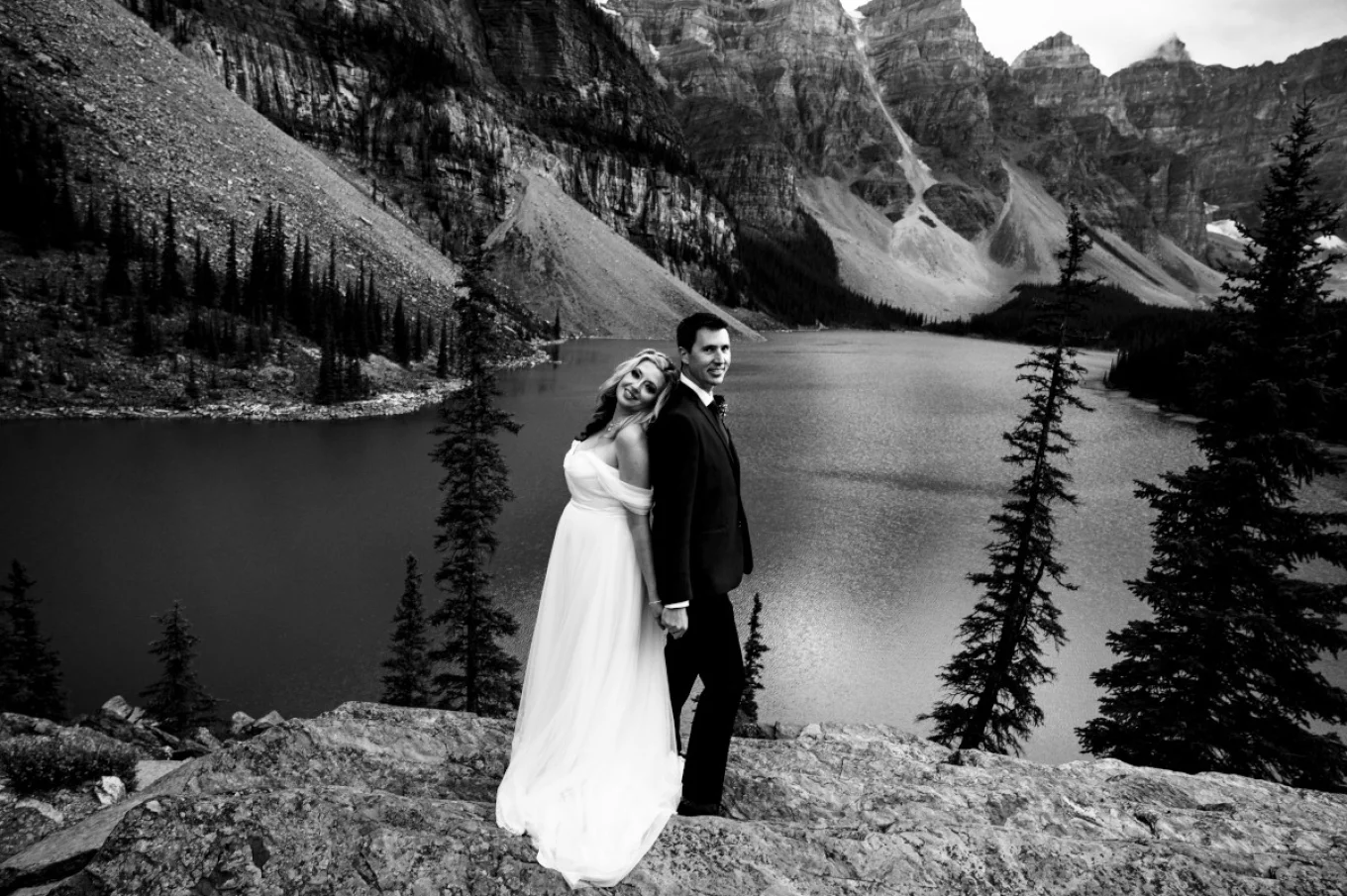 Moraine Lake wedding portrait in black and white. Newlyweds look at the Banff Wedding Photographer camera and smiles.