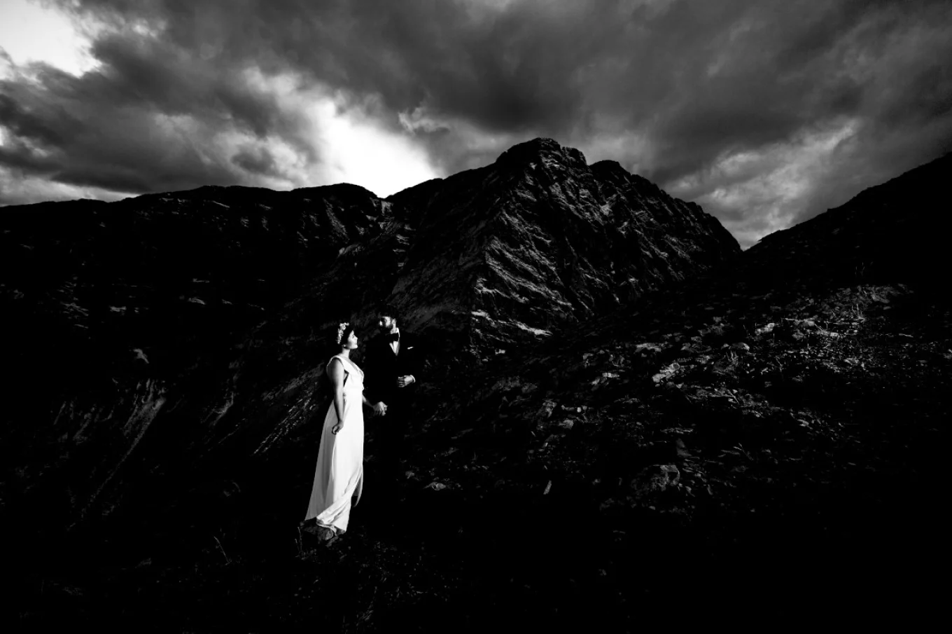 Groom and Bride look at the tremendous Canadian Rockies during Wedding Mountain Session in Banff.