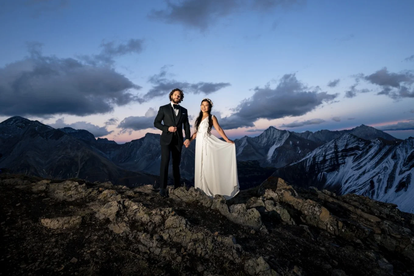 Newlyweds celebrate their love by reaching the peak of the mountain in Banff. Banff Wedding Mountain Photography.