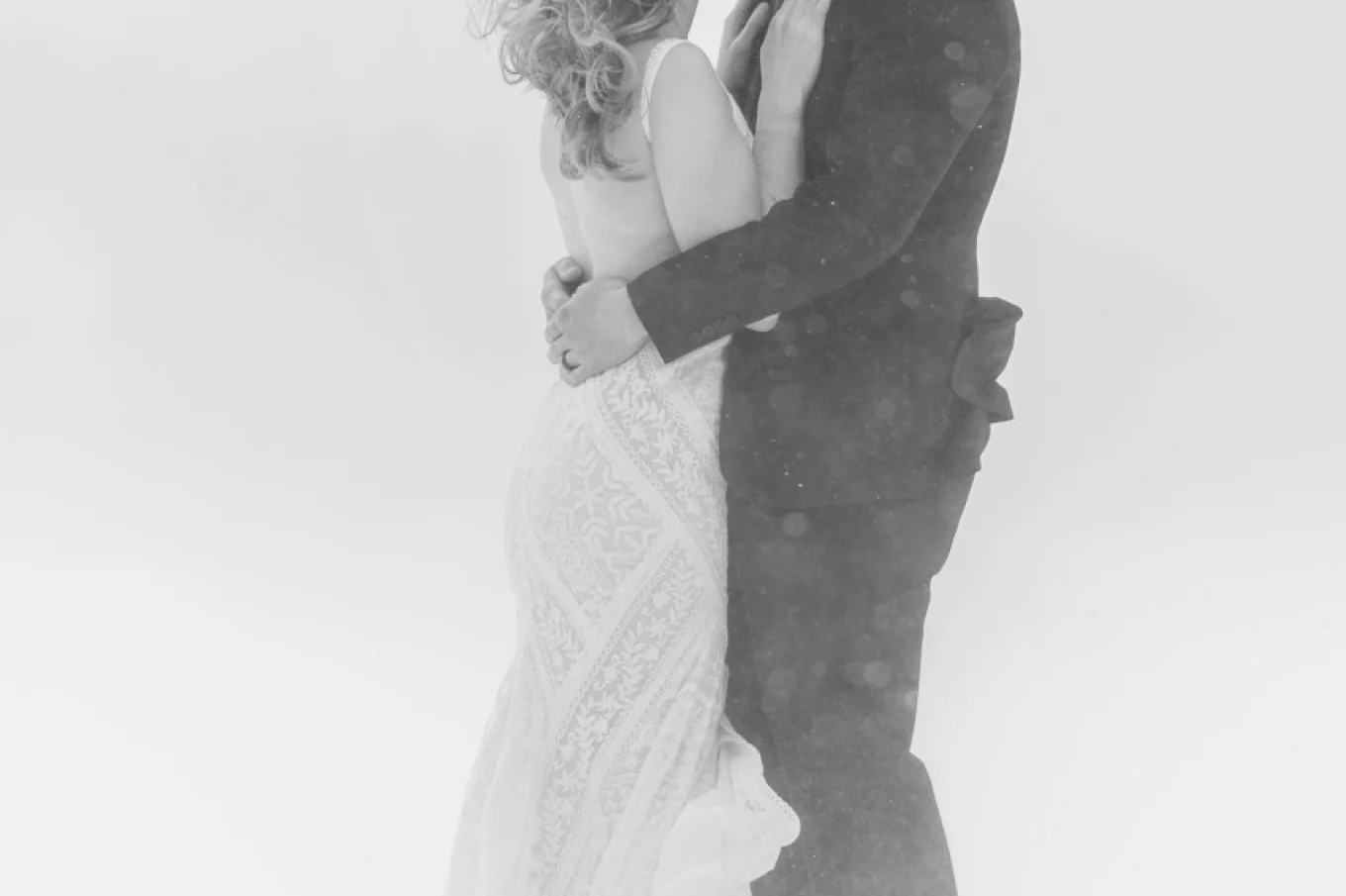 Newlyweds share a kiss during the winter storm in Banff. i