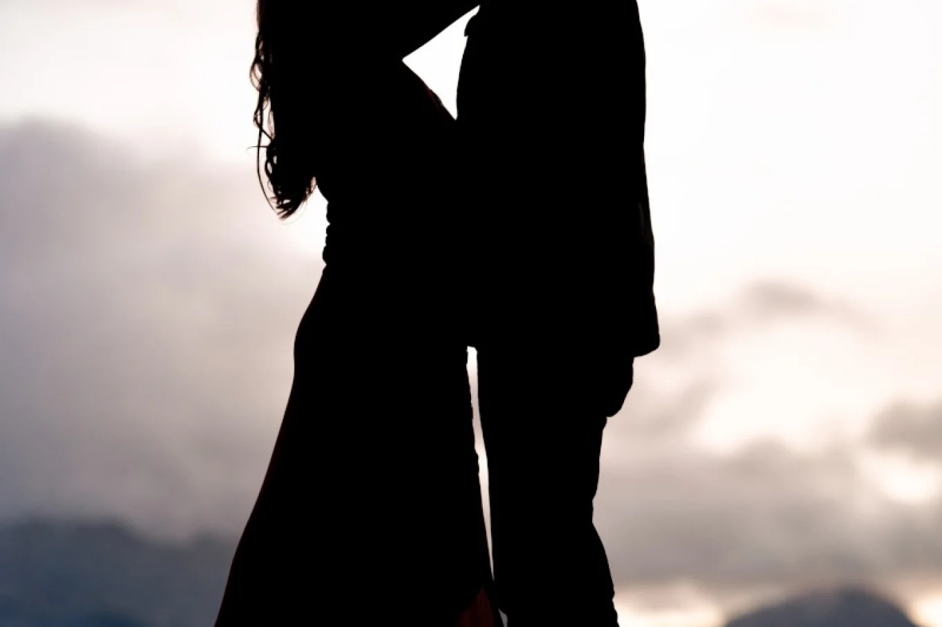 Engagen couple hug each other and look deeply at each other eyes in Banff