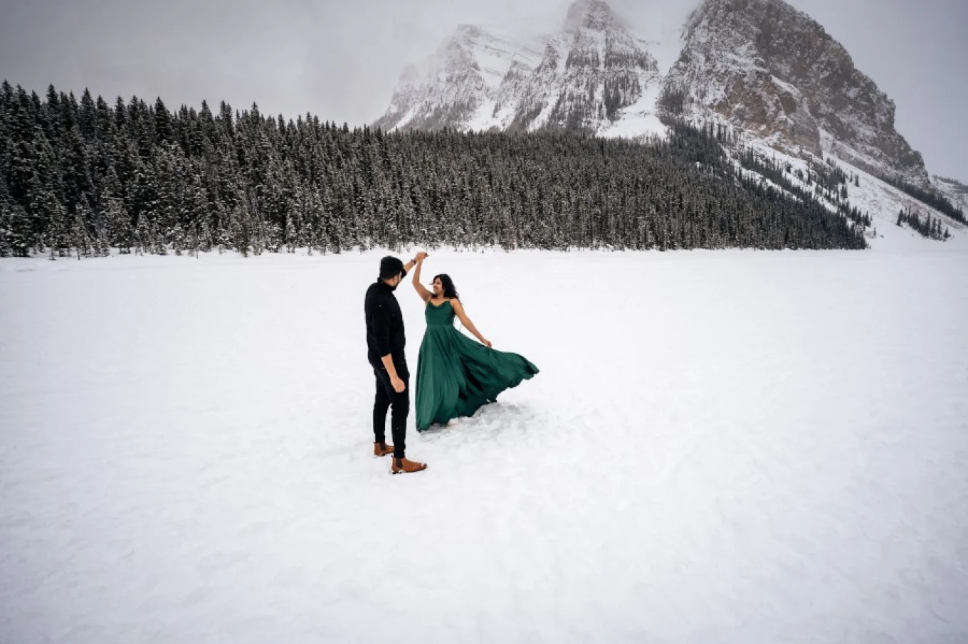 Indian couple dance in the snow.