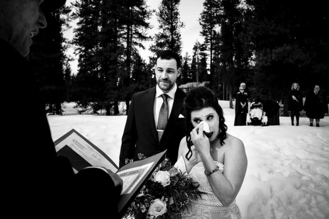 Bride cries during wedding ceremony in the Canadian Rockies.