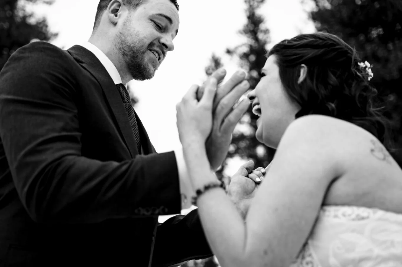 Happy newlyweds smile to each others.