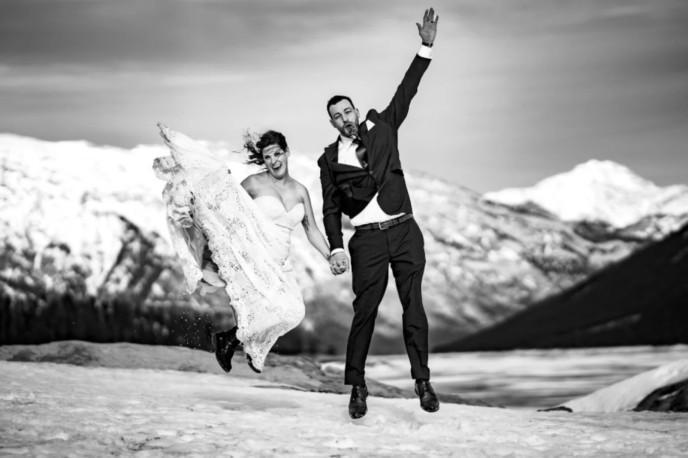 Newlyweds jump high. They have fun.