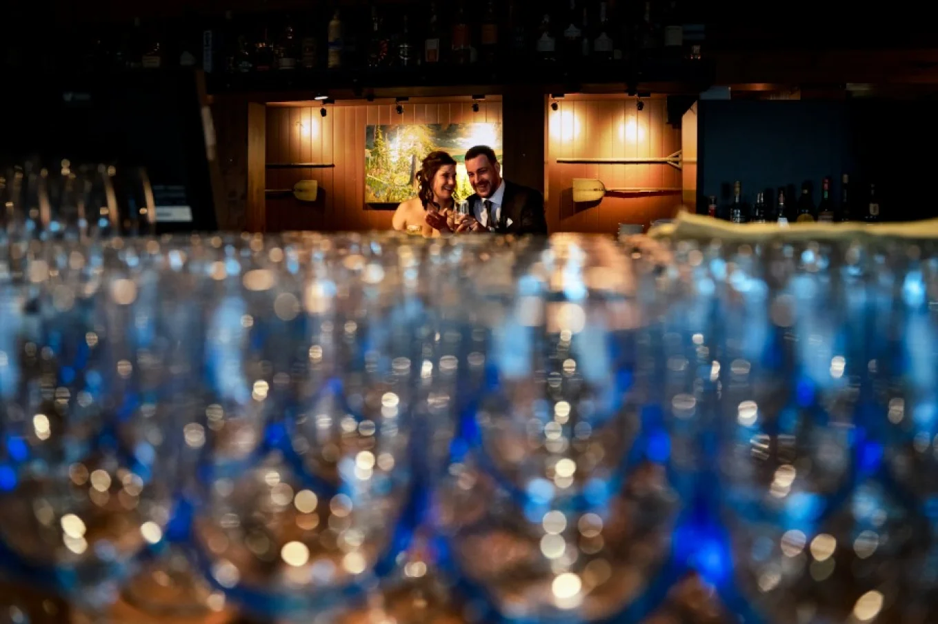 Wedding Reception. Bride and groom sit at the bar and talk.