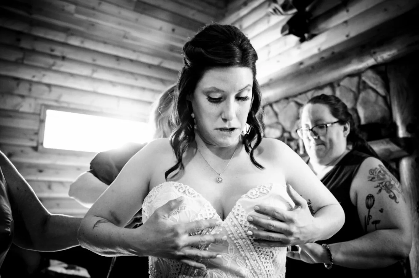 Bride puts a wedding dress on.