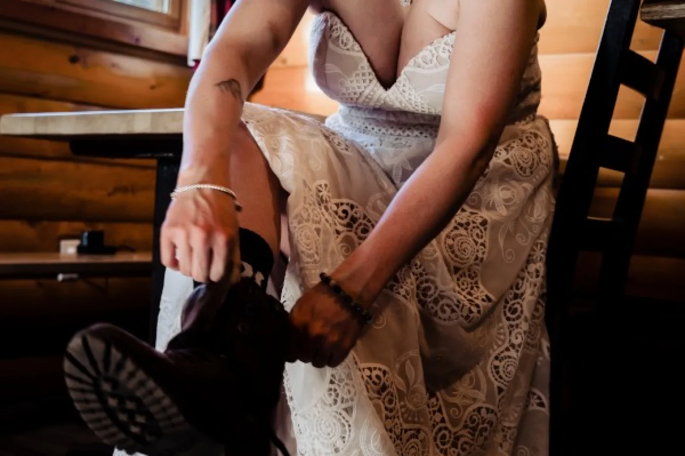 The bride puts hiking buts on before winter Banff elopement.