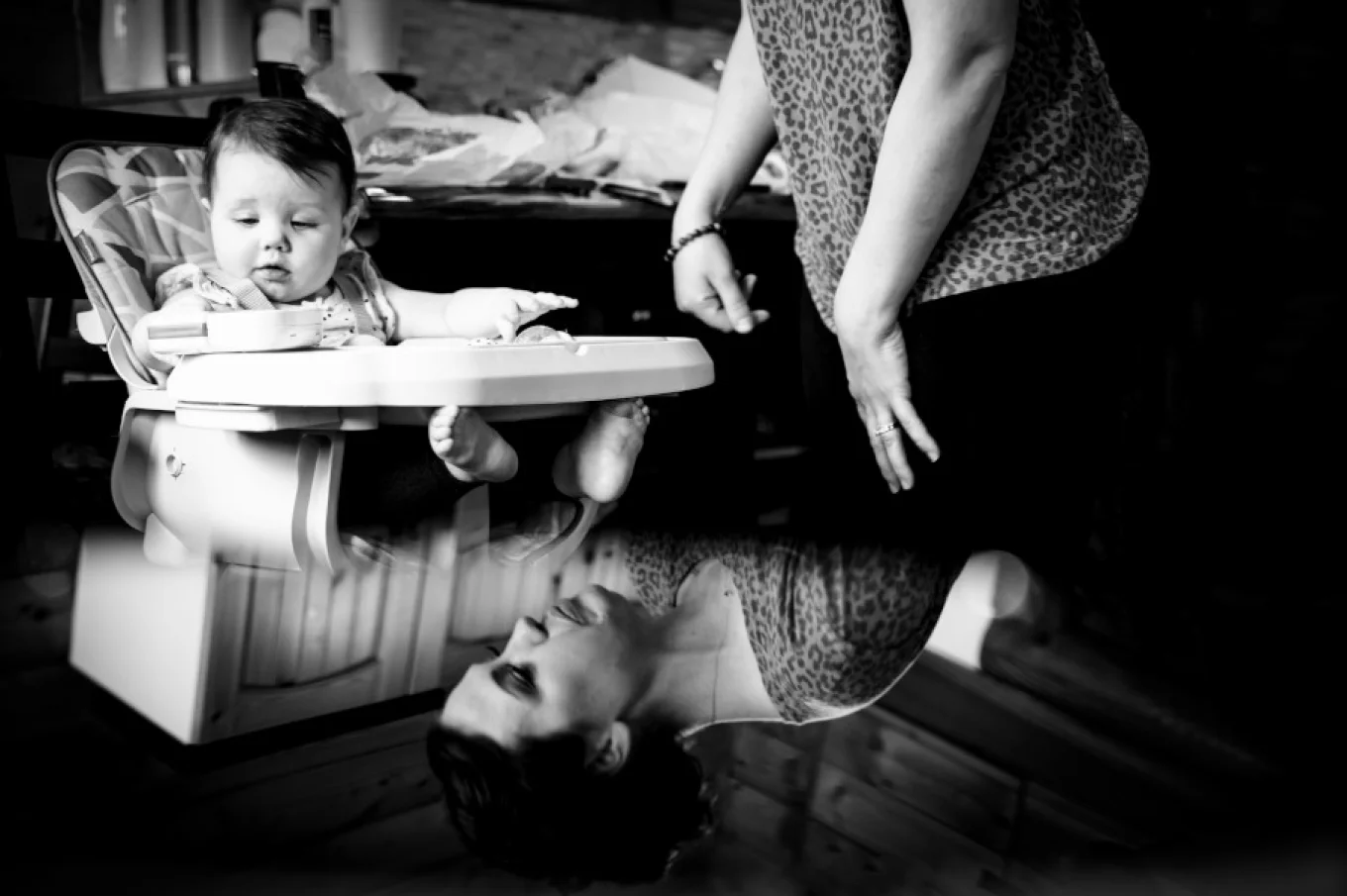 creative photo of mother and a baby. Mirror reflection in black and white.
