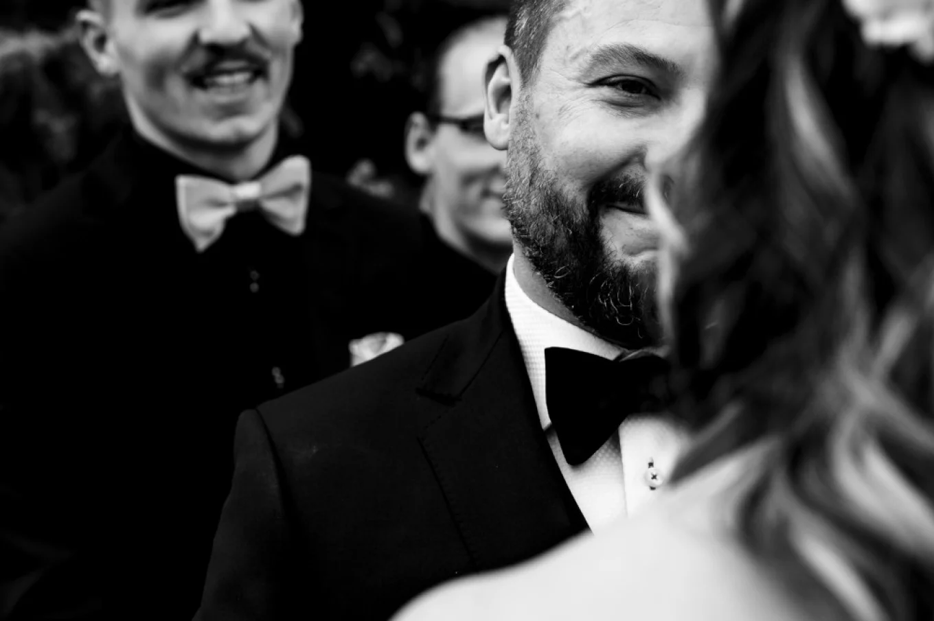 groom with tears in his eyes during Banff Wedding. Best-man smiles.