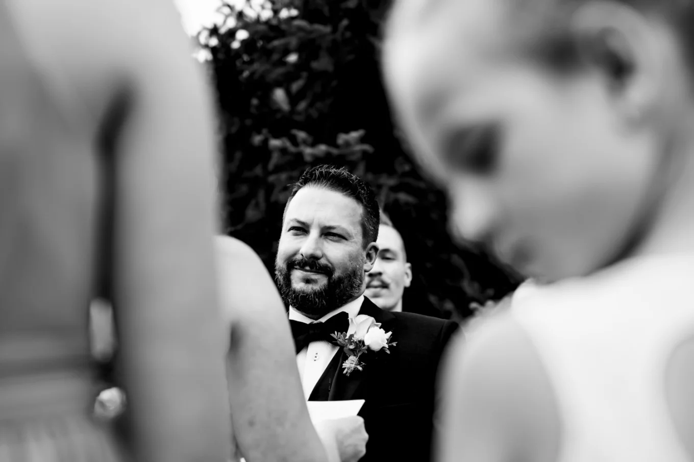 Groom's speech in black and white with flower girl on the foreground.