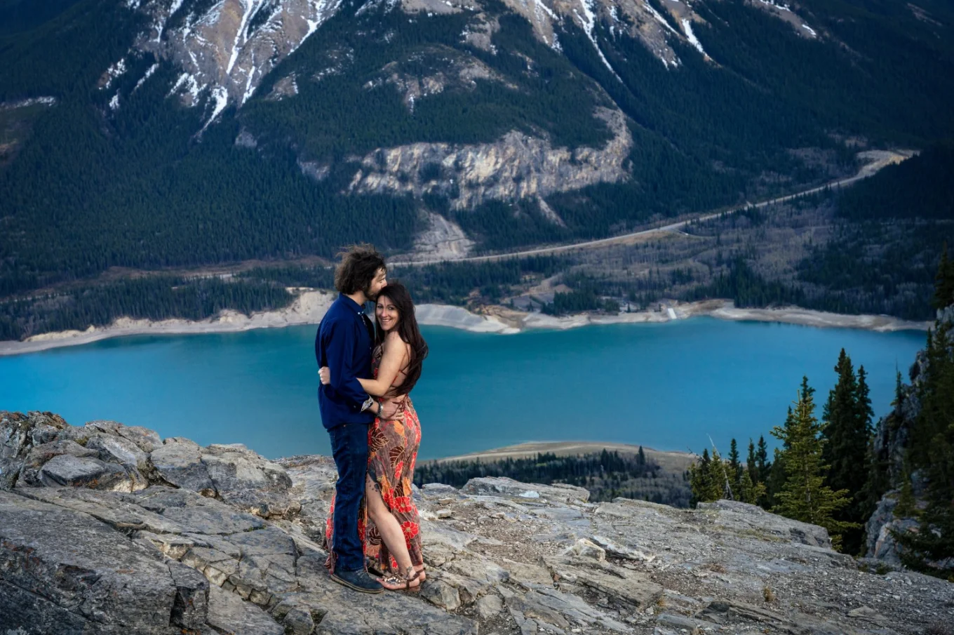 Canadian posed couple standing on the peak on the mountain,