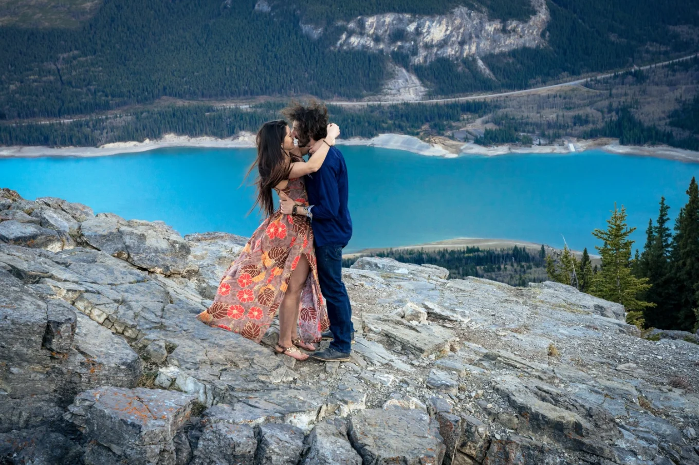 Couple share a kiss during their engagement session in the Canadian Rockies. Moment captured by the best Banff Wedding Photographer.