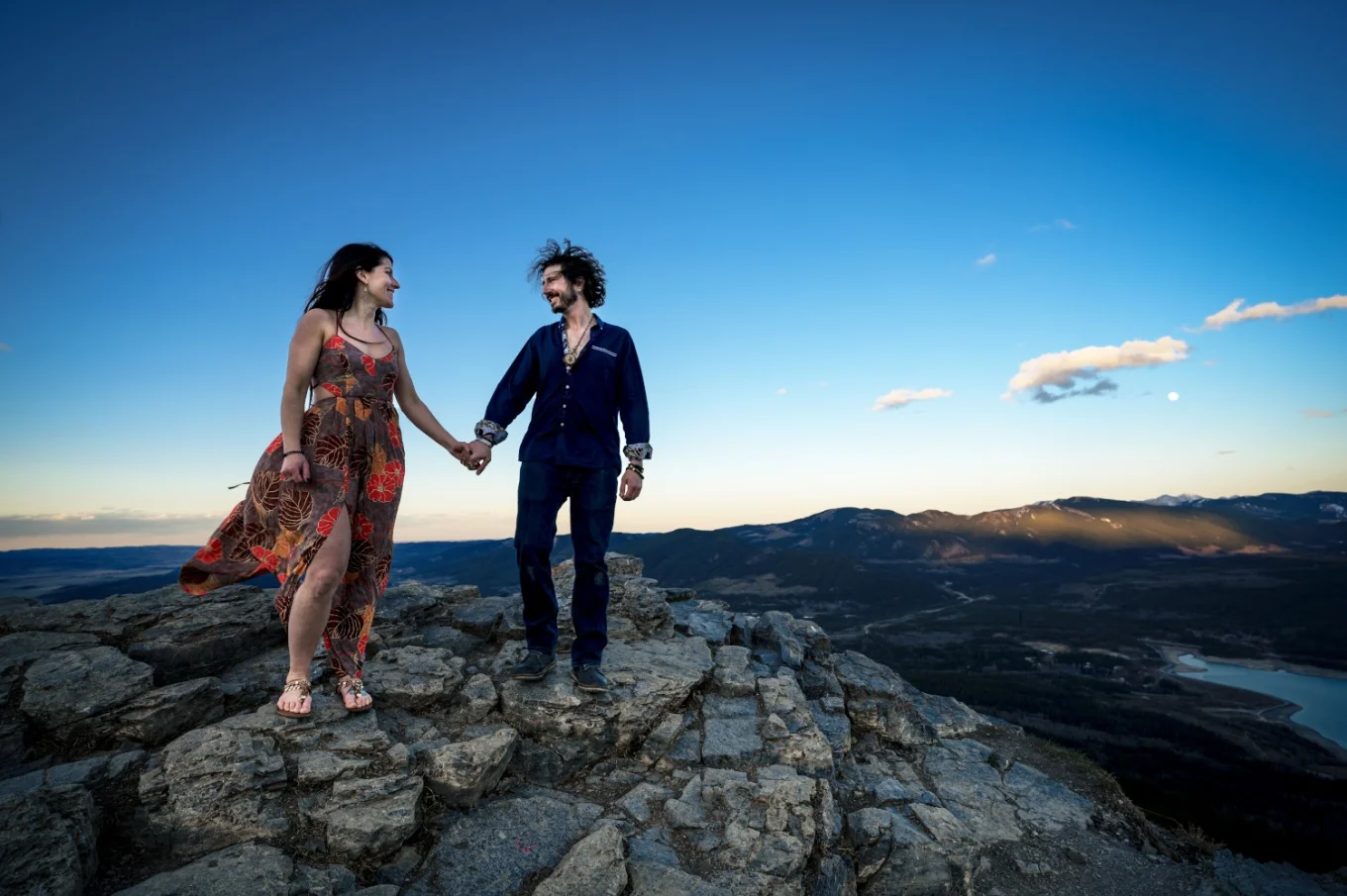 couple look at each other during their adventure session close to Banff.