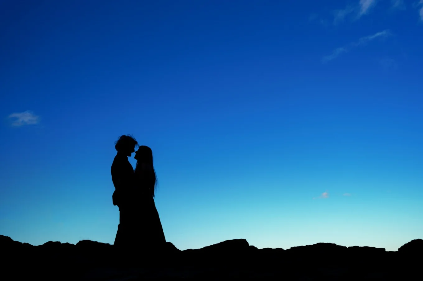 Silhouette picture of fleshly engaged couple in love.