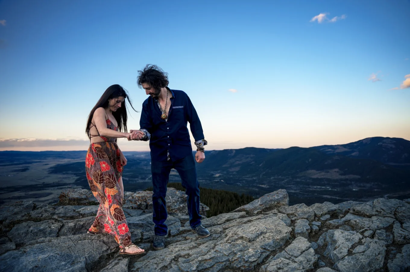 Gentleman helps his fiancée while hiking in Banff.