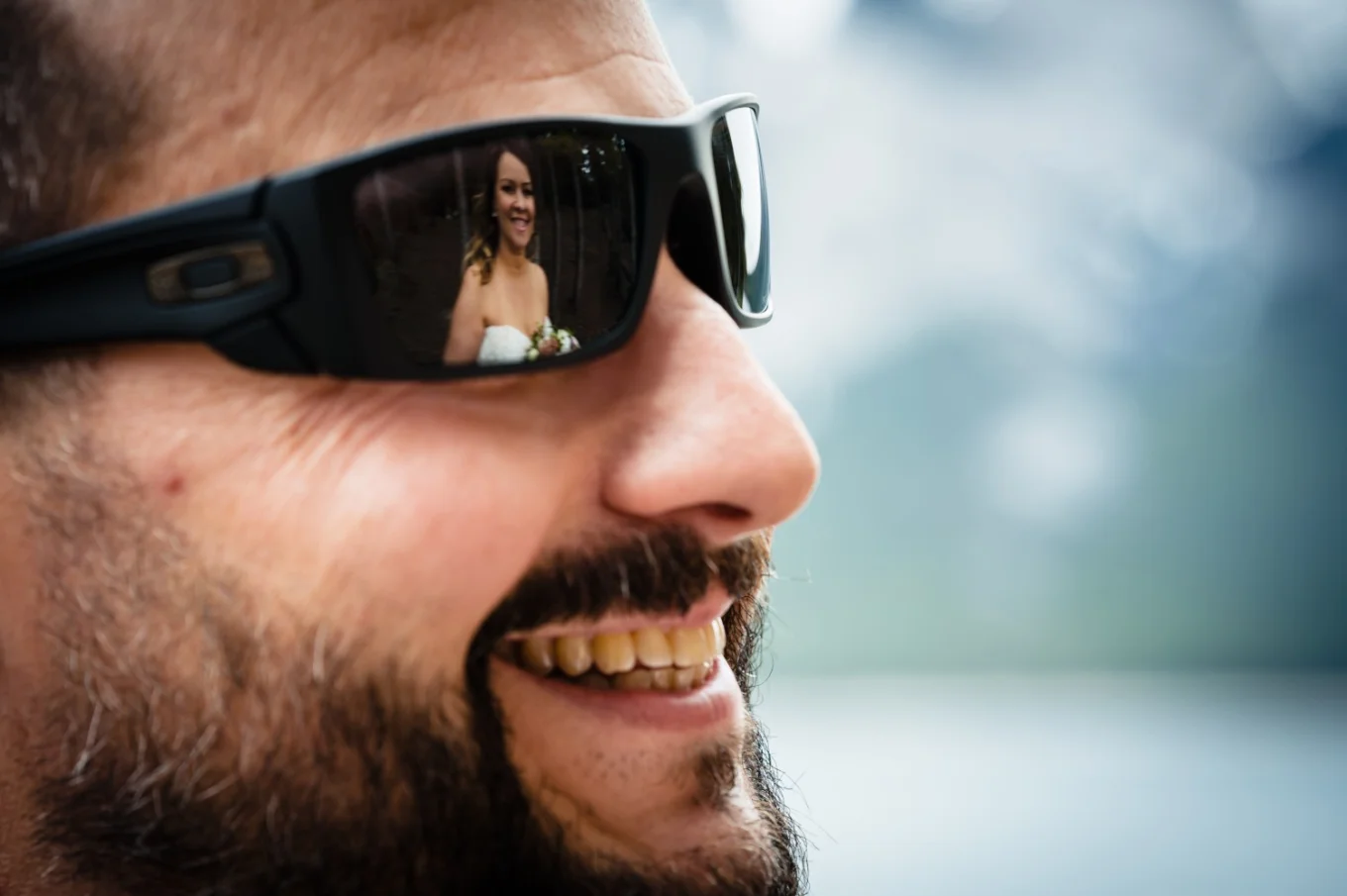 bride's reflection in the groom's sunglasses