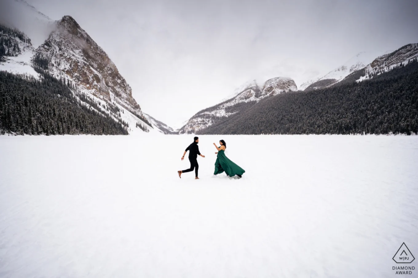 Engaged couple run into each other at the frozen Lake Louise.